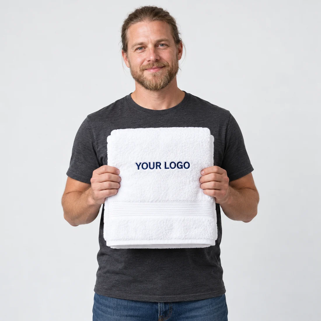 Model holding a white towel embroidered with YOUR LOGO