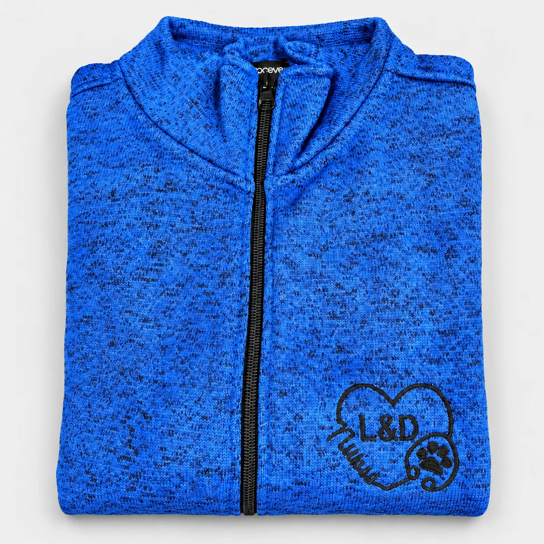Blue zip-up jacket with an embroidered heart and stethoscope