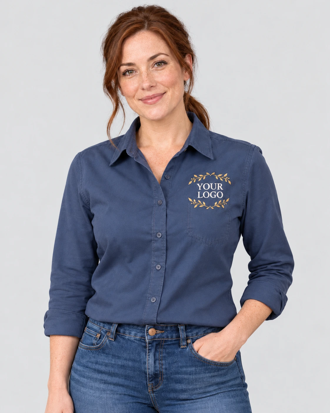 Adult wearing a blue work shirt with gold laurel YOUR LOGO embroidery