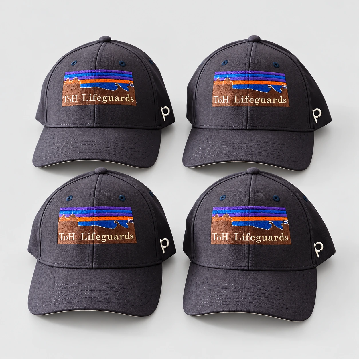 Four dark caps with ToH Lifeguards embroidery